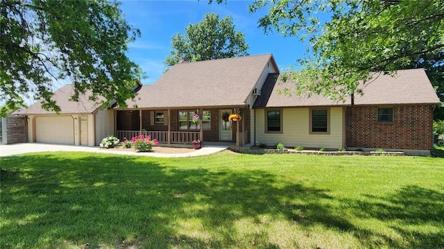 19819 Mclouth Rd, Tonganoxie, KS 66086 - view of front of house featuring covered porch, a garage, a front yard, and driveway