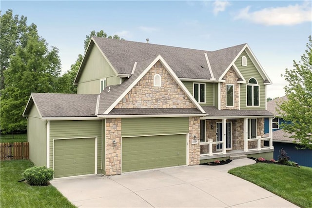 10154 N Lane Dr, Kansas City, MO 64157 - craftsman house with covered porch, stone siding, an attached garage, concrete driveway, and a shingled roof