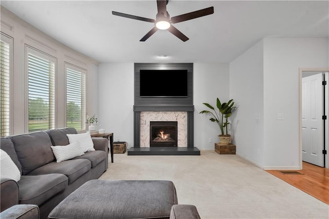 10154 N Lane Dr, Kansas City, MO 64157 - carpeted living room with a ceiling fan, a high end fireplace, and baseboards