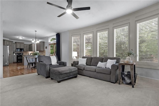 10154 N Lane Dr, Kansas City, MO 64157 - living area featuring ceiling fan, a chandelier, and carpet flooring