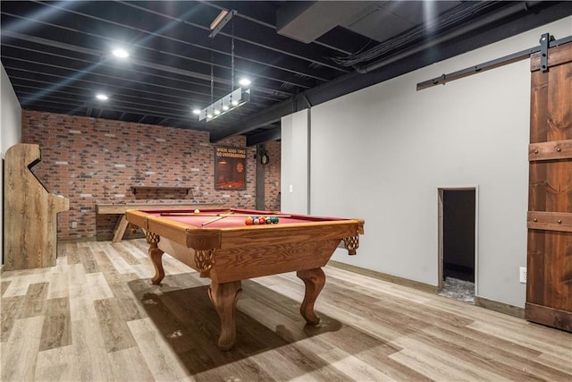10154 N Lane Dr, Kansas City, MO 64157 - recreation room with brick wall, a barn door, wood finished floors, pool table, and baseboards