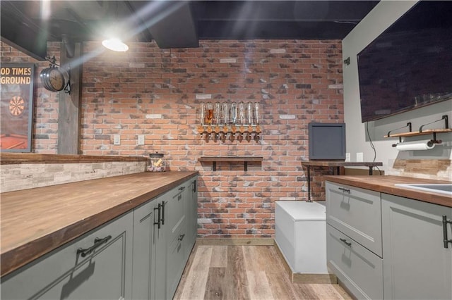 10154 N Lane Dr, Kansas City, MO 64157 - bathroom with brick wall and wood finished floors