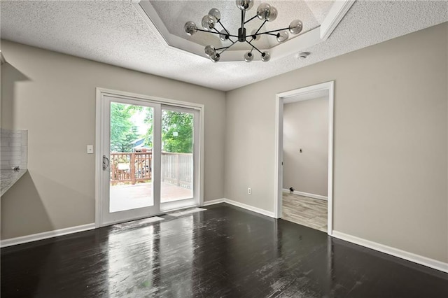 1609 NE Jade Ct, Lees Summit, MO 64086 - unfurnished dining area featuring a textured ceiling, wood finished floors, a chandelier, and baseboards