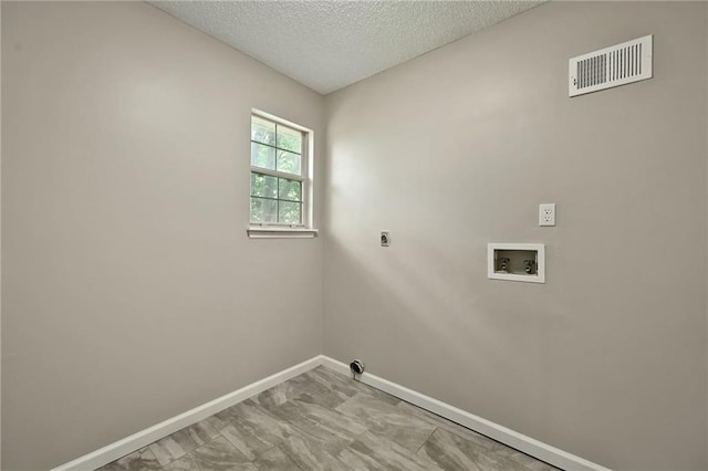 1609 NE Jade Ct, Lees Summit, MO 64086 - washroom featuring washer hookup, baseboards, a textured ceiling, and hookup for an electric dryer
