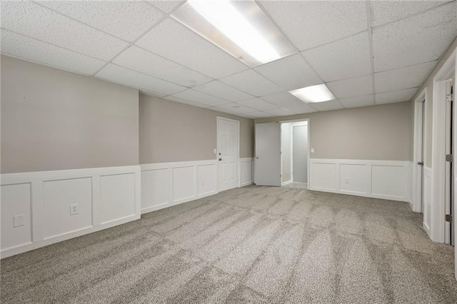 1609 NE Jade Ct, Lees Summit, MO 64086 - spare room with a paneled ceiling, carpet floors, a decorative wall, and wainscoting