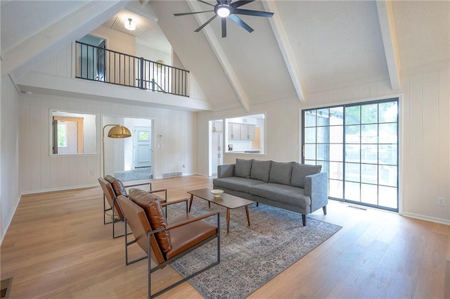 9100 Dearborn St, Overland Park, KS 66207 - living area with beam ceiling, light wood-style floors, a ceiling fan, and high vaulted ceiling