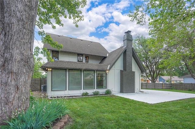 9100 Dearborn St, Overland Park, KS 66207 - back of property featuring a patio area, a chimney, a sunroom, and roof with shingles