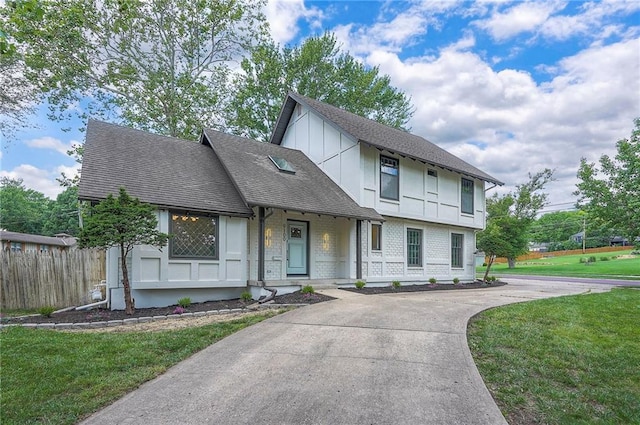 9100 Dearborn St, Overland Park, KS 66207 - english style home with brick siding, a shingled roof, and concrete driveway