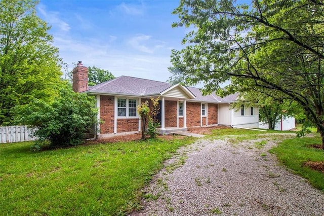 4188 Country Squire Ln, Oak Grove, MO 64075 - ranch-style home with gravel driveway, a chimney, and brick siding