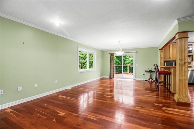 4188 Country Squire Ln, Oak Grove, MO 64075 - unfurnished living room with ornamental molding, wood finished floors, ornate columns, baseboards, and a textured ceiling
