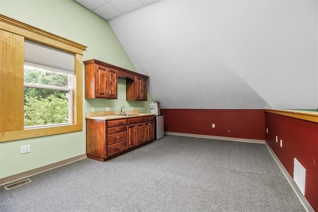 4188 Country Squire Ln, Oak Grove, MO 64075 - bar area with light carpet, baseboards, vaulted ceiling, and a sink