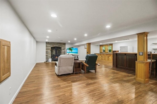 4188 Country Squire Ln, Oak Grove, MO 64075 - living area featuring wood finished floors, recessed lighting, ornate columns, and baseboards