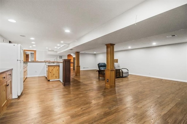 4188 Country Squire Ln, Oak Grove, MO 64075 - unfurnished living room with wood finished floors, recessed lighting, baseboards, and a sink