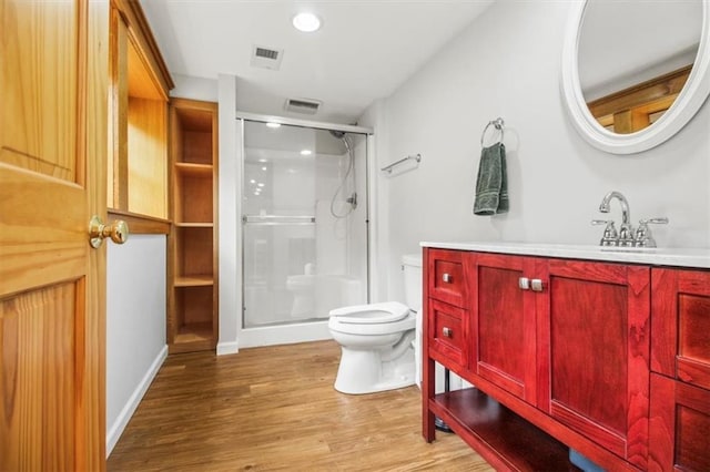 4188 Country Squire Ln, Oak Grove, MO 64075 - full bathroom featuring toilet, a stall shower, vanity, wood finished floors, and recessed lighting