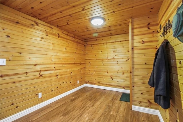 4188 Country Squire Ln, Oak Grove, MO 64075 - spare room featuring baseboards, wood finished floors, wood walls, and wood ceiling