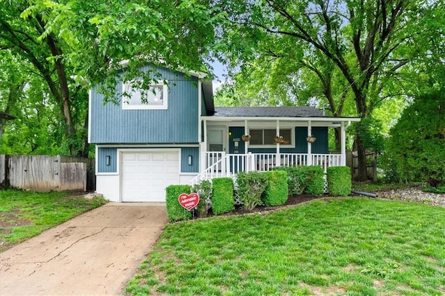 4400 Elledge Dr, Roeland Park, KS 66205 - split level home with a porch, driveway, and a garage