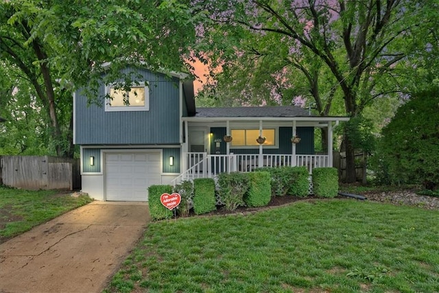 4400 Elledge Dr, Roeland Park, KS 66205 - split level home featuring a porch, driveway, and a garage