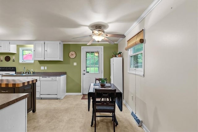 4400 Elledge Dr, Roeland Park, KS 66205 - kitchen featuring white dishwasher, crown molding, white cabinetry, plenty of natural light, and light carpet