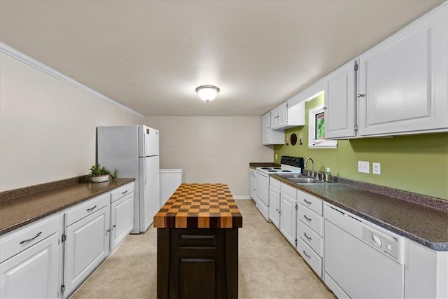 4400 Elledge Dr, Roeland Park, KS 66205 - kitchen with white appliances, a sink, white cabinetry, crown molding, and a kitchen island