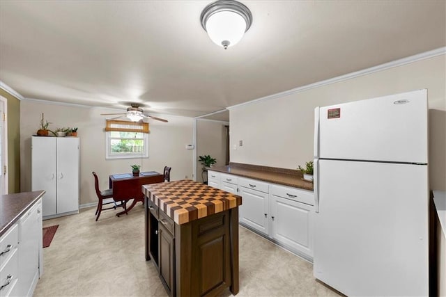 4400 Elledge Dr, Roeland Park, KS 66205 - kitchen featuring freestanding refrigerator, a ceiling fan, ornamental molding, butcher block counters, and a kitchen island