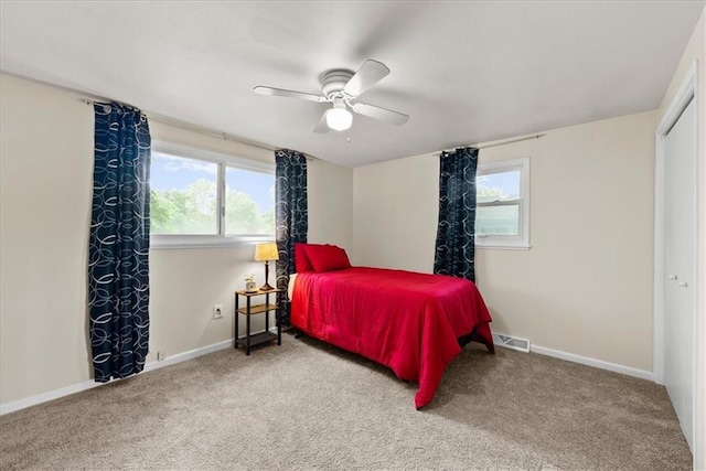 4400 Elledge Dr, Roeland Park, KS 66205 - carpeted bedroom with multiple windows, baseboards, ceiling fan, and a closet