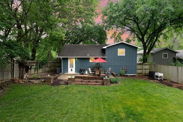 4400 Elledge Dr, Roeland Park, KS 66205 - back of property at dusk with board and batten siding and a patio
