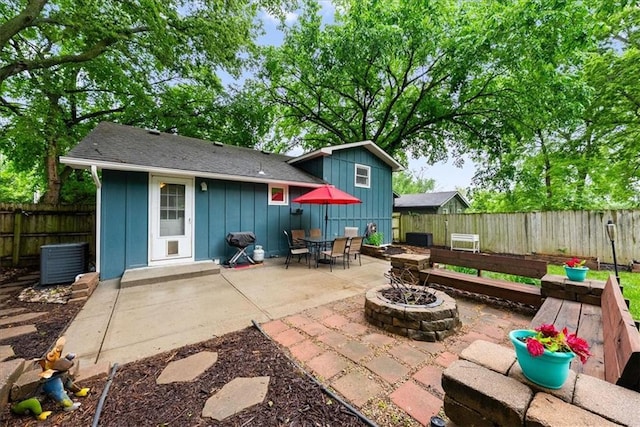 4400 Elledge Dr, Roeland Park, KS 66205 - fenced backyard featuring a fire pit, a patio, and central air condition unit