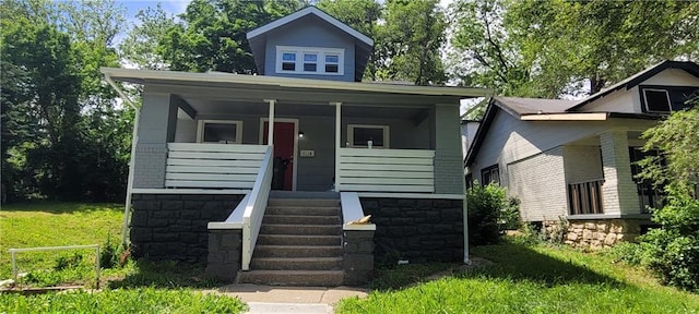 5118 Wabash Ave, Kansas City, MO 64130 - bungalow-style home featuring covered porch and stone siding