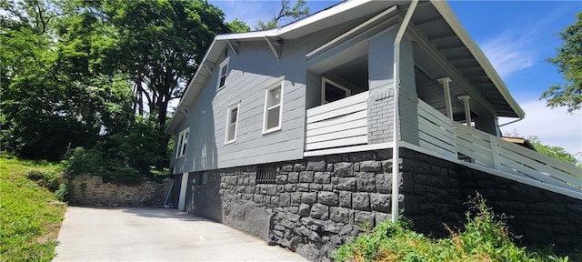5118 Wabash Ave, Kansas City, MO 64130 - view of property exterior featuring concrete driveway and stone siding