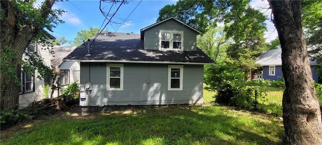 5118 Wabash Ave, Kansas City, MO 64130 - rear view of house featuring a lawn and a shingled roof