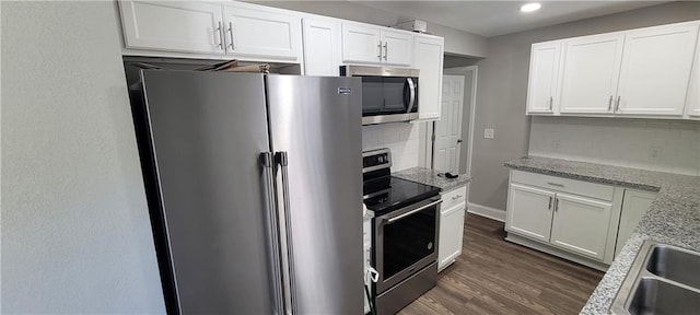 5118 Wabash Ave, Kansas City, MO 64130 - kitchen featuring stainless steel appliances, tasteful backsplash, white cabinetry, dark wood-style flooring, and recessed lighting