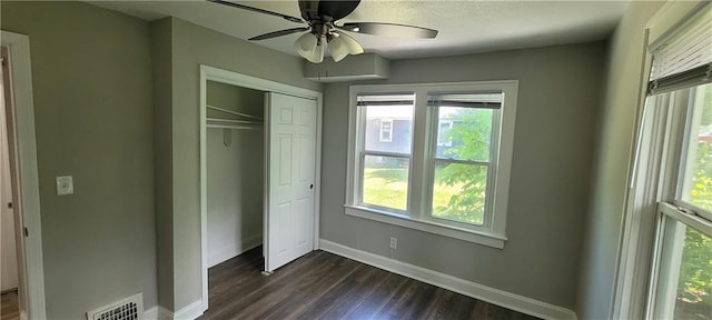 5118 Wabash Ave, Kansas City, MO 64130 - unfurnished bedroom with baseboards, dark wood-style floors, a closet, and a ceiling fan