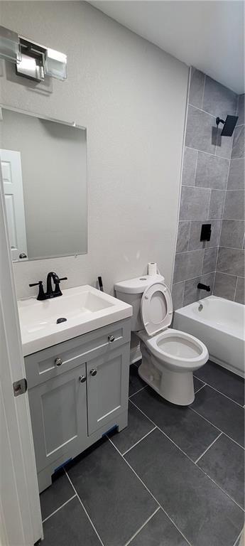 5118 Wabash Ave, Kansas City, MO 64130 - full bathroom featuring vanity, toilet, tile patterned floors, and  shower combination