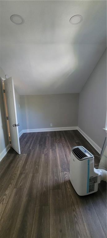 5118 Wabash Ave, Kansas City, MO 64130 - bonus room featuring dark wood-style floors, lofted ceiling, and baseboards