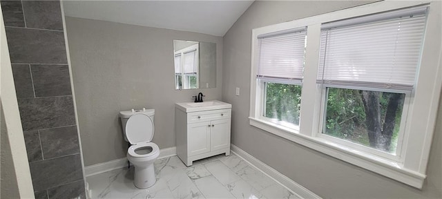 5118 Wabash Ave, Kansas City, MO 64130 - bathroom with marble finish flooring, vanity, toilet, baseboards, and lofted ceiling