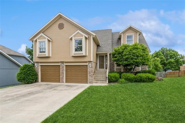 5309 NE Rainbow Cir, Lees Summit, MO 64064 - view of front of house featuring brick siding, an attached garage, and driveway