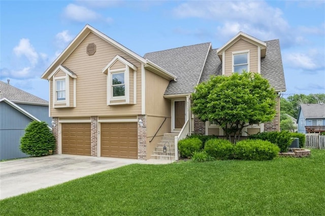5309 NE Rainbow Cir, Lees Summit, MO 64064 - view of front of property with brick siding, a front lawn, concrete driveway, and an attached garage