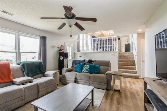 5309 NE Rainbow Cir, Lees Summit, MO 64064 - living area featuring wood finished floors, stairway, ceiling fan, and a chandelier