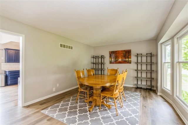 5309 NE Rainbow Cir, Lees Summit, MO 64064 - dining space featuring healthy amount of natural light, wood finished floors, and baseboards