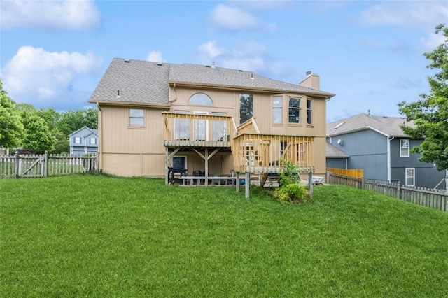 5309 NE Rainbow Cir, Lees Summit, MO 64064 - back of property featuring a deck, a chimney, and a shingled roof