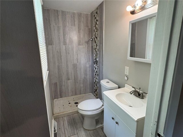 3006 S Santa Fe Rd, Independence, MO 64055 - bathroom with a stall shower, toilet, vanity, and wood finished floors