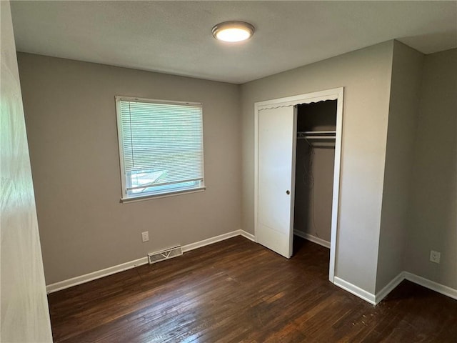 3006 S Santa Fe Rd, Independence, MO 64055 - unfurnished bedroom with wood finished floors, baseboards, and a closet