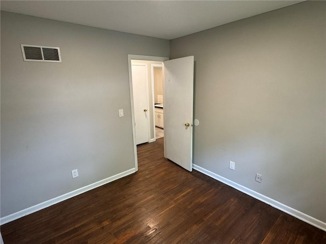 3006 S Santa Fe Rd, Independence, MO 64055 - unfurnished room featuring baseboards and dark wood-type flooring
