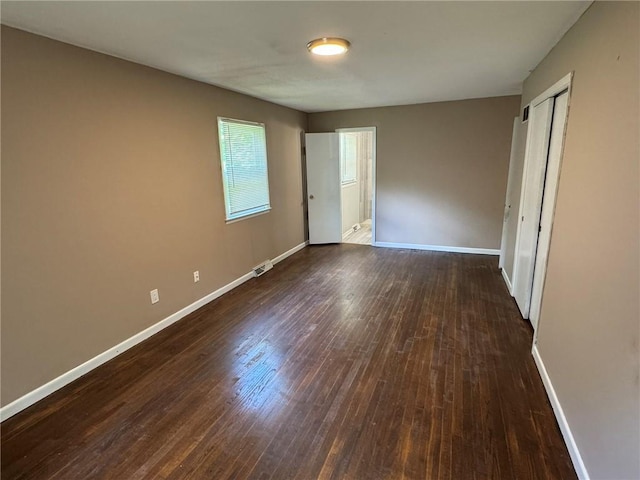 3006 S Santa Fe Rd, Independence, MO 64055 - unfurnished bedroom featuring dark wood-style flooring, baseboards, and a closet