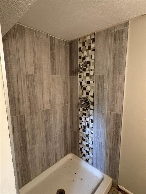 3006 S Santa Fe Rd, Independence, MO 64055 - bathroom featuring a textured ceiling and a tile shower