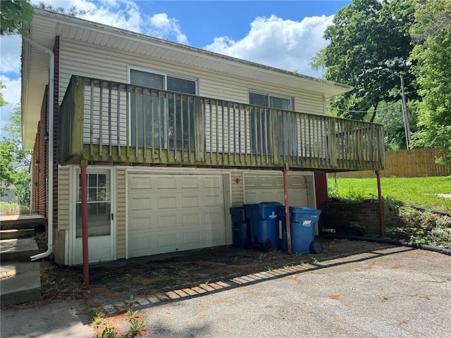 3006 S Santa Fe Rd, Independence, MO 64055 - back of house with a garage and asphalt driveway