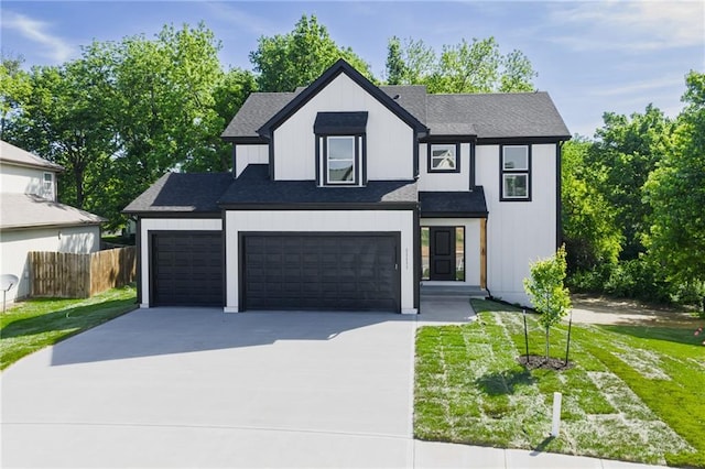 11147 Rowland Ave, Kansas City, KS 66109 - view of front of property with driveway, roof with shingles, and a garage