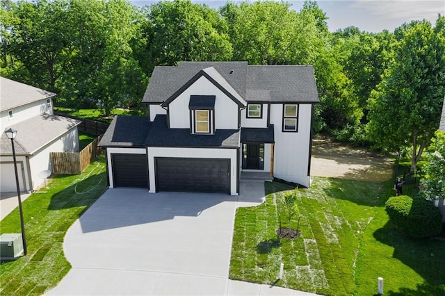 11147 Rowland Ave, Kansas City, KS 66109 - view of front of house with concrete driveway, roof with shingles, and an attached garage