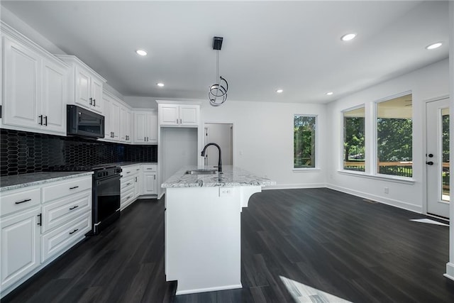 11147 Rowland Ave, Kansas City, KS 66109 - kitchen featuring black appliances, a sink, plenty of natural light, dark wood-style floors, and recessed lighting