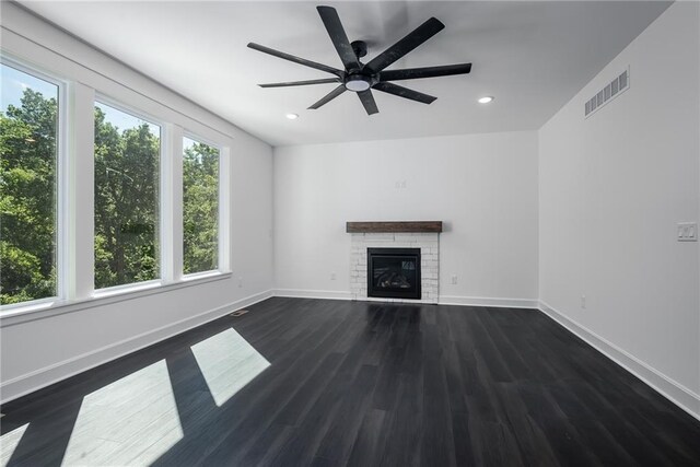 11147 Rowland Ave, Kansas City, KS 66109 - unfurnished living room featuring recessed lighting, ceiling fan, a glass covered fireplace, dark wood-style floors, and baseboards